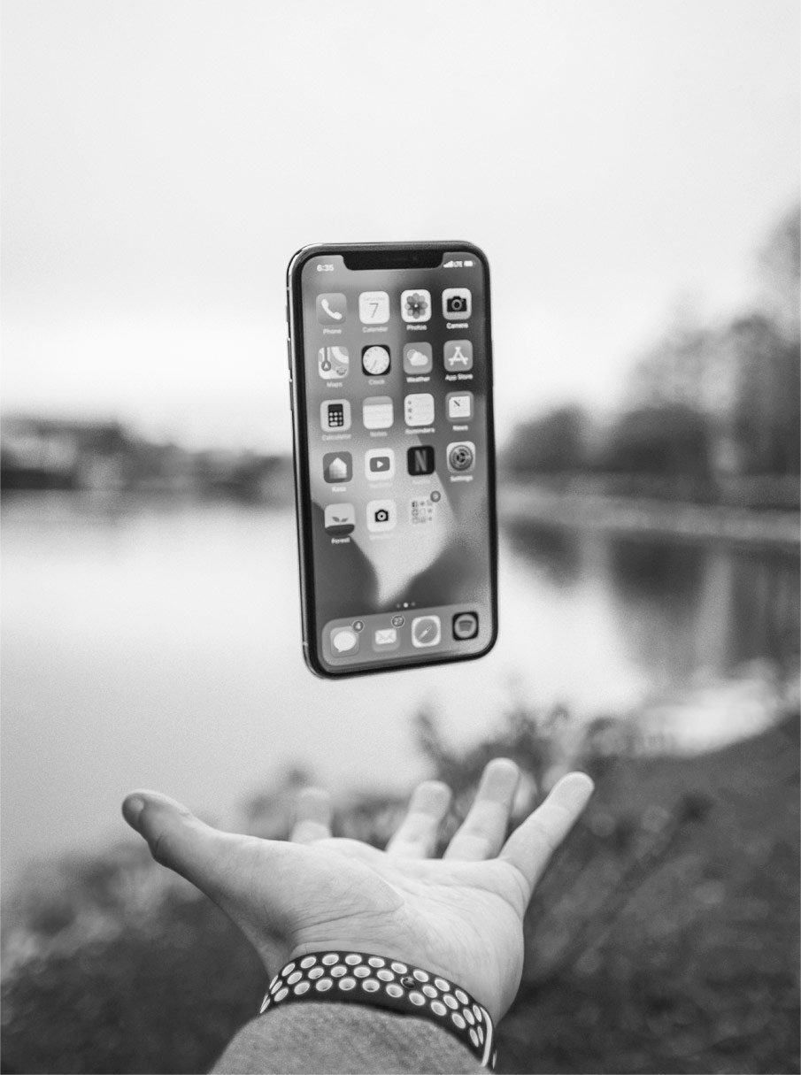 mano lanzando un iphone hacia arriba